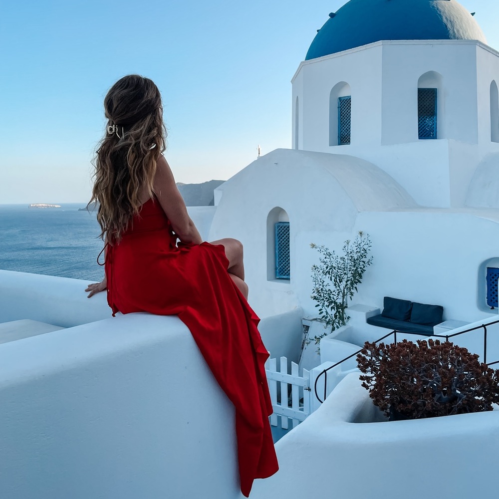 Red flowy dress with low laced back. High slit with ruffles.